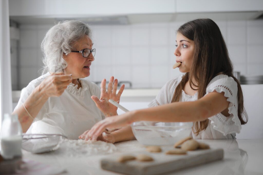 Elderly woman having a meal with junior